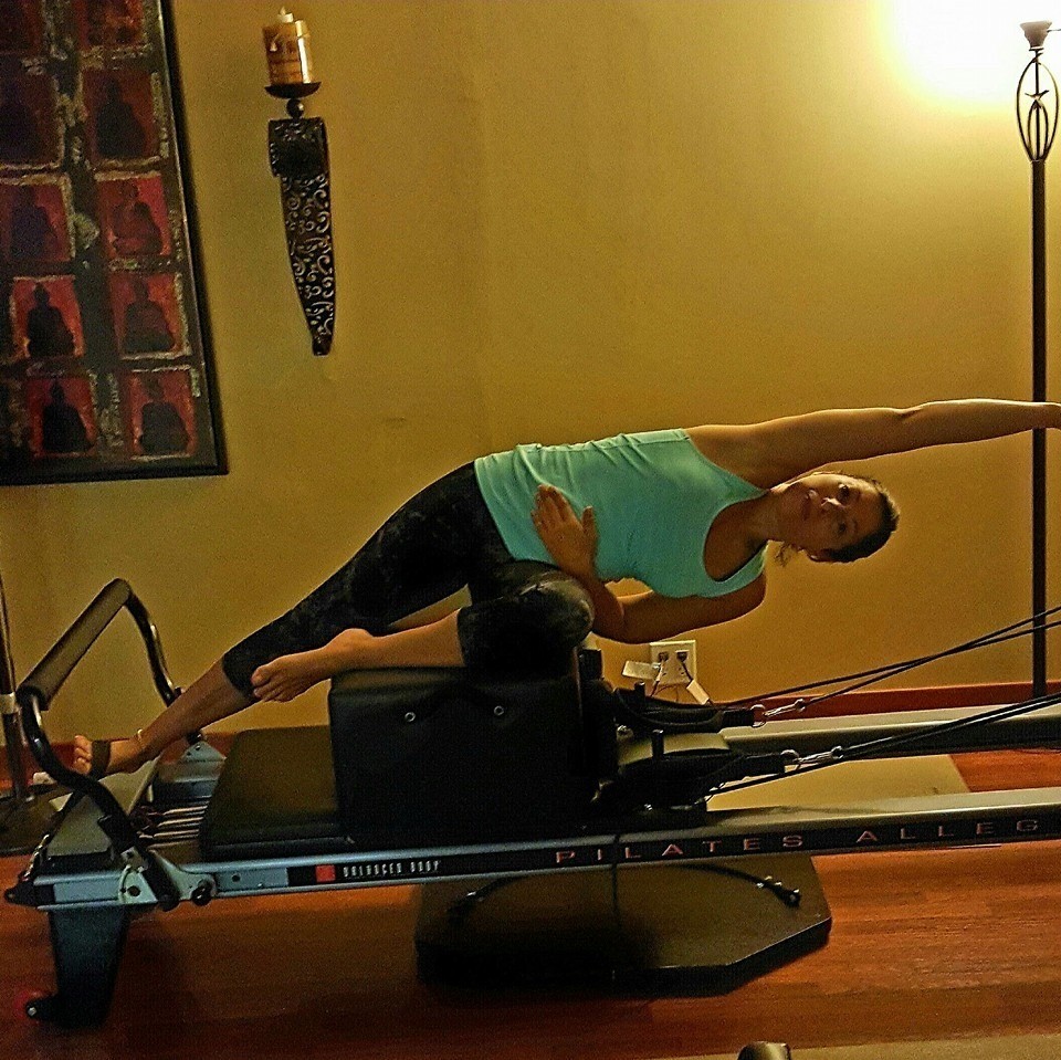 Woman Stretching On The Pilates Reformer